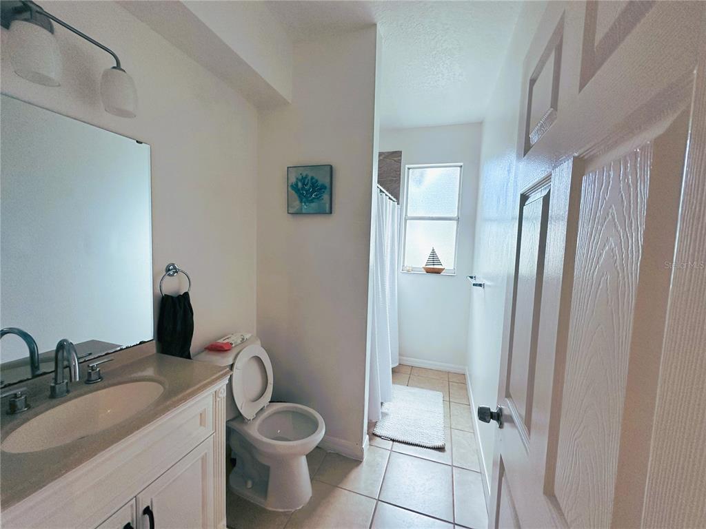 700 Castillo Place St. Cloud, FL 34769 - Photo 21 of 43 a bathroom with a granite countertop toilet and a sink