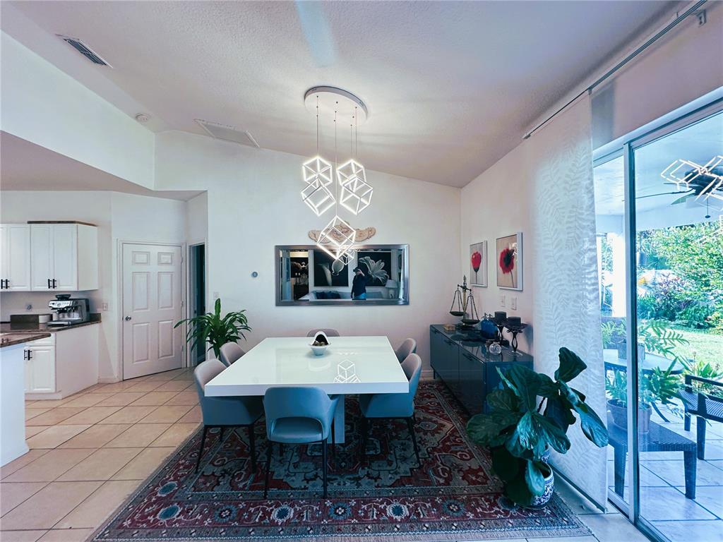 700 Castillo Place St. Cloud, FL 34769 - Photo 26 of 43 a view of a dining room with furniture window and wooden floor