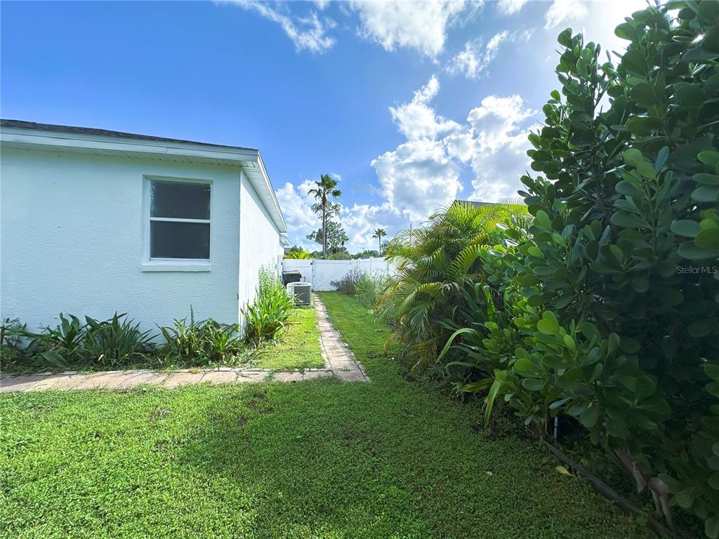 700 Castillo Place St. Cloud, FL 34769 - Photo 37 of 43 a view of a house with a yard