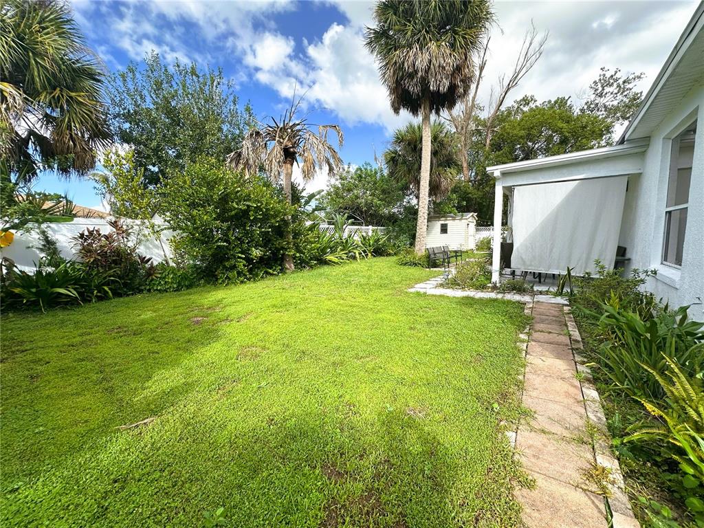 700 Castillo Place St. Cloud, FL 34769 - Photo 38 of 43 a front view of a house with garden
