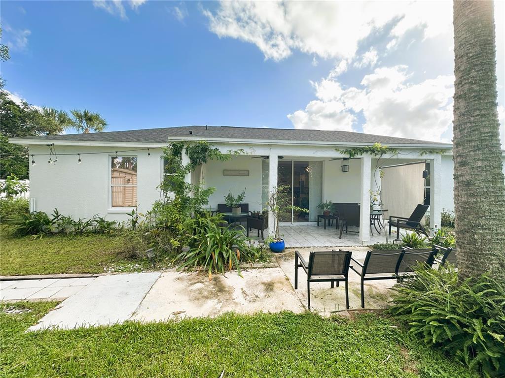 700 Castillo Place St. Cloud, FL 34769 - Photo 40 of 43 a view of a house with backyard sitting area and garden