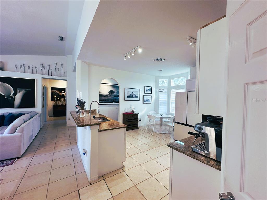 700 Castillo Place St. Cloud, FL 34769 - Photo 6 of 43 a living room with furniture a flat screen tv and a table