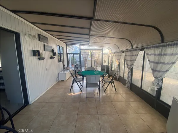 a dining room with furniture and a window