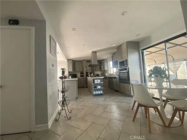 a kitchen with furniture and a refrigerator