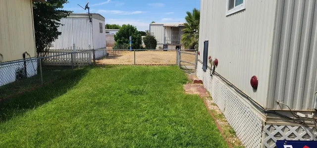 a view of house with backyard and outdoor seating