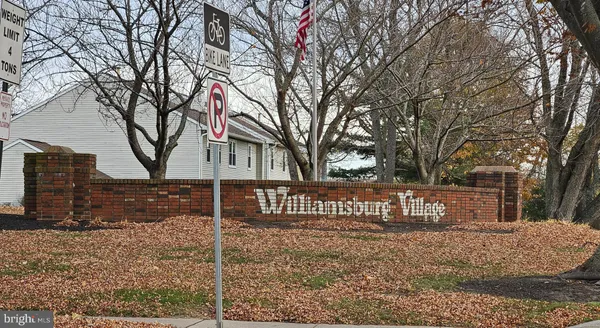a kitchen with stainless steel appliances granite countertop a stove a refrigerator and a sink with wooden floors