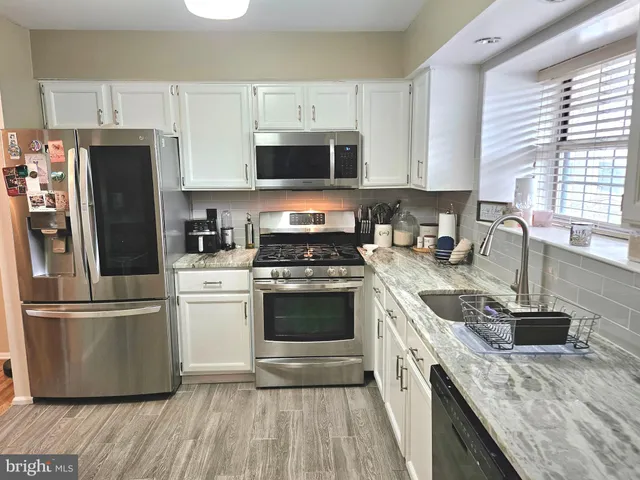 a view of a dining room with furniture and window