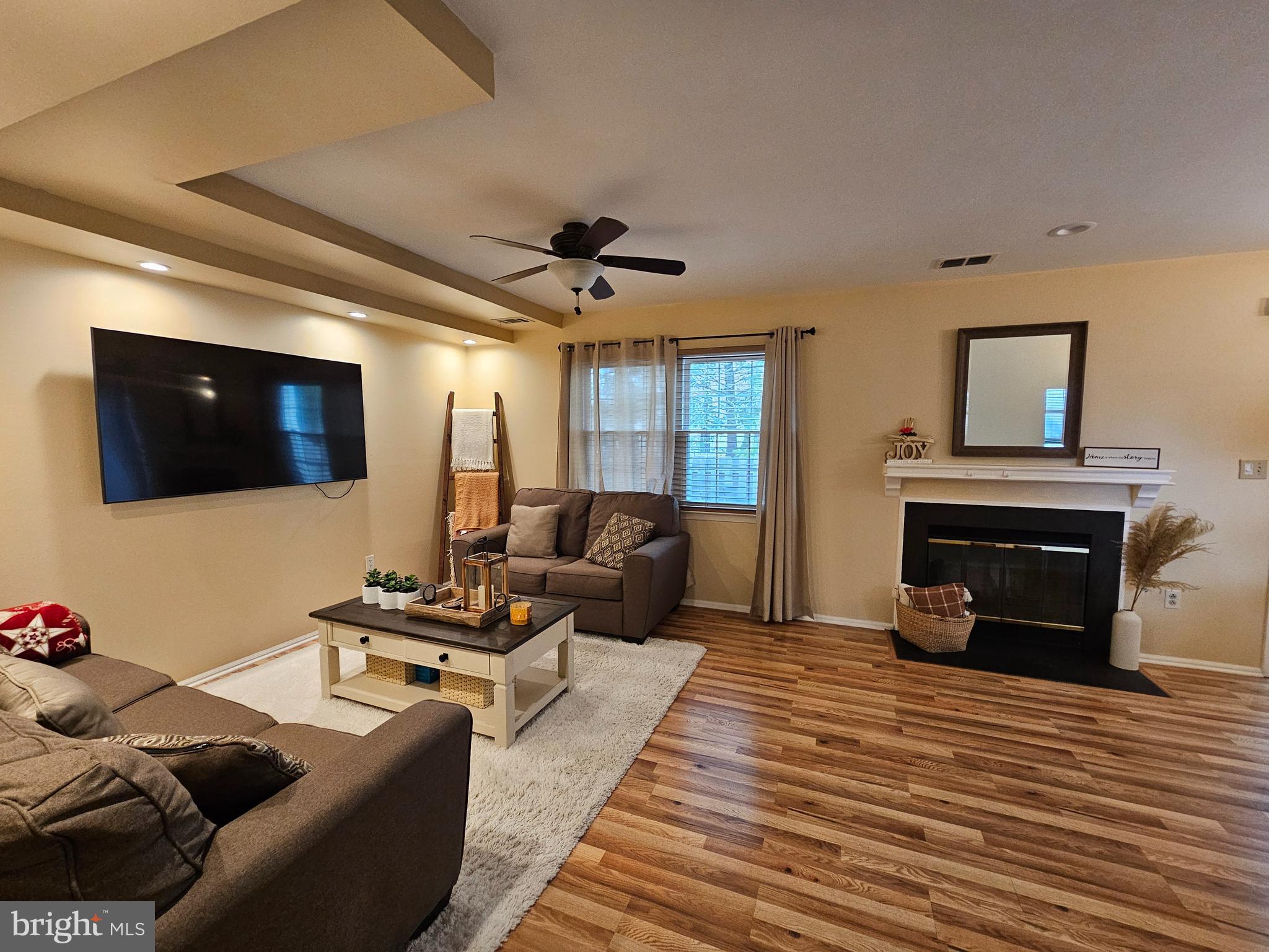 17 Exeter Court Bordentown, NJ 08505 - Photo 6 of 19 a living room with furniture a flat screen tv and a fireplace