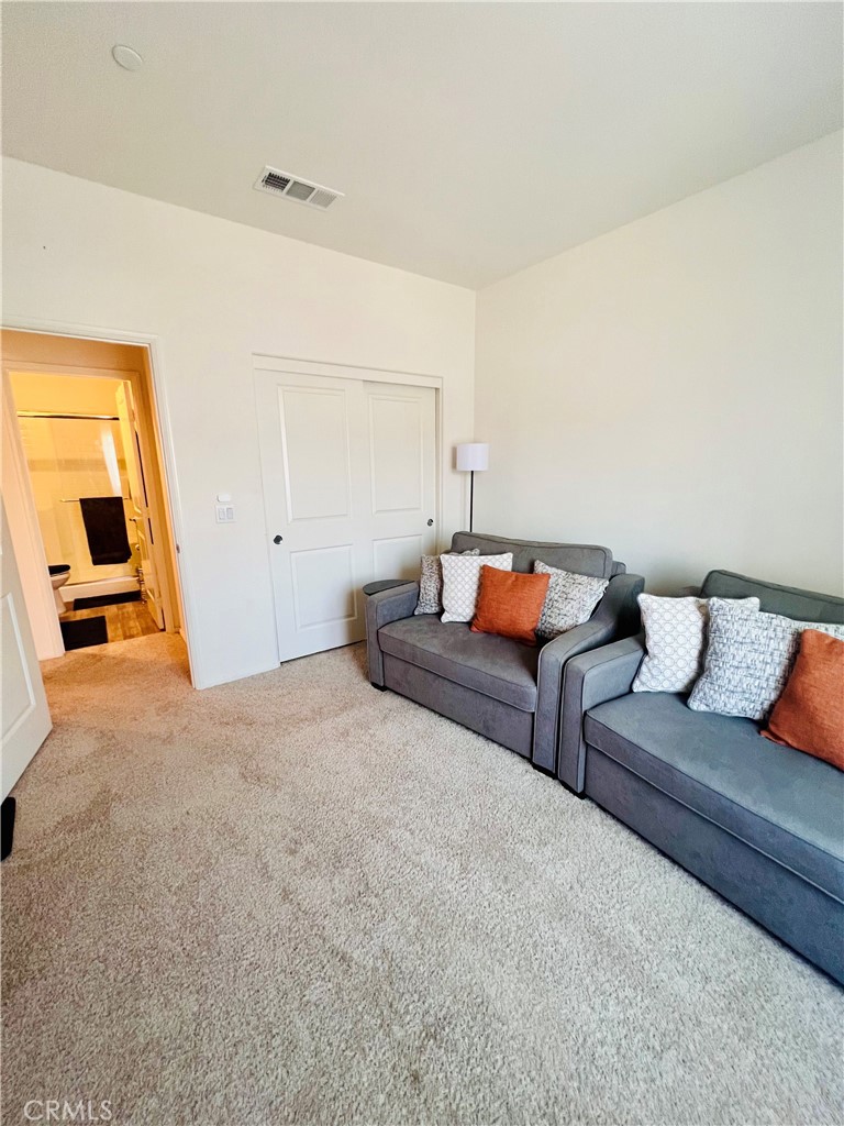 31381 Linden Flower Road Winchester, CA 92596 - Photo 14 of 33 Downstairs secondary bedroom as sitting area. Full closet and convenient bath.