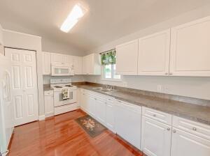 780 2nd Street Southwest Vero Beach, FL 32962 - Photo 18 of 21 a kitchen with granite countertop white cabinets and white appliances