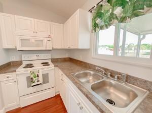 780 2nd Street Southwest Vero Beach, FL 32962 - Photo 19 of 21 a kitchen with a sink stove and cabinets