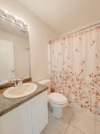 780 2nd Street Southwest Vero Beach, FL 32962 - Photo 21 of 21 a bathroom with a granite countertop sink a toilet and a mirror