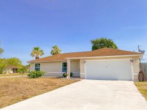 780 2nd Street Southwest Vero Beach, FL 32962 - Photo 6 of 21 a front view of a house with a yard and garage