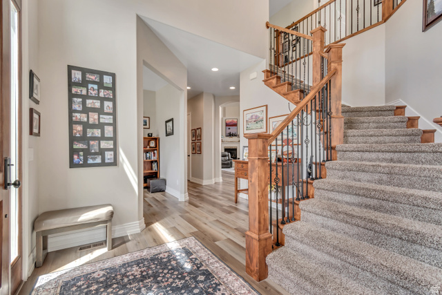2543 East 700 South Springville, UT 84663 - Photo 14 of 73 Foyer with light wood-style floors, recessed lighting, a fireplace, and a high ceiling