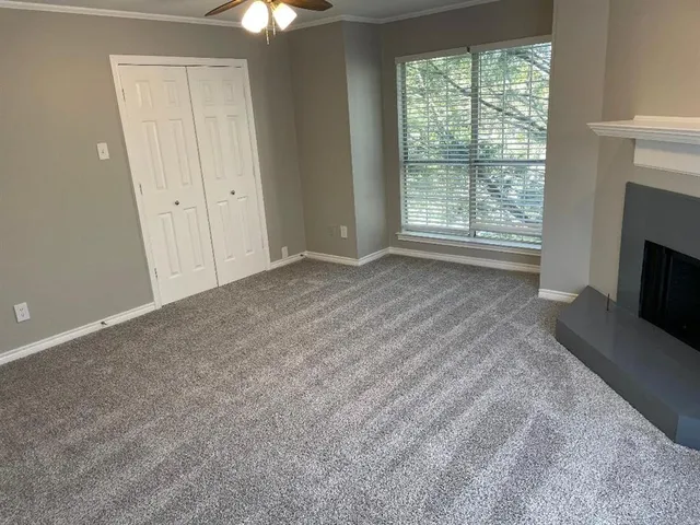 a view of empty room with window and fireplace