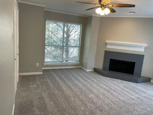 a view of empty room with window and fireplace