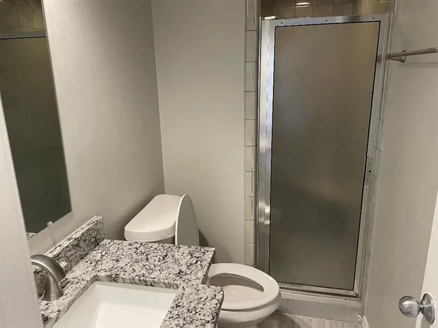 a bathroom with a toilet and a shower