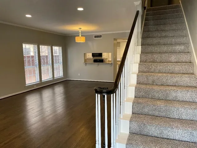 a view of entryway and hall with wooden floor