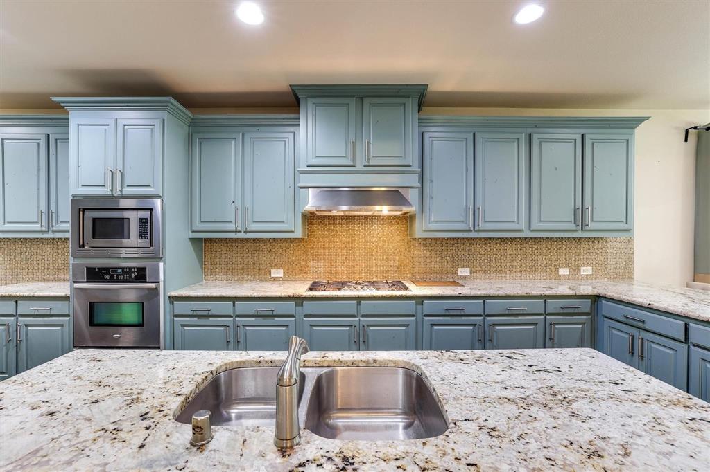 419 Rio Grande Drive Irving, TX 75039 - Photo 12 of 29 Kitchen featuring light blue cabinetry and granite countertops