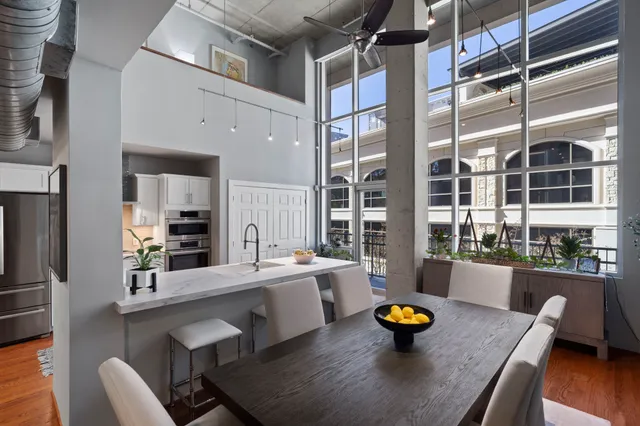 a kitchen with a sink a counter and chairs