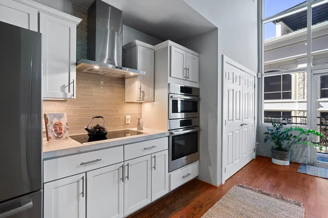 a kitchen with stainless steel appliances a refrigerator and cabinets