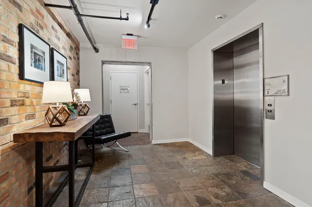 a view of a hallway and a livingroom with furniture