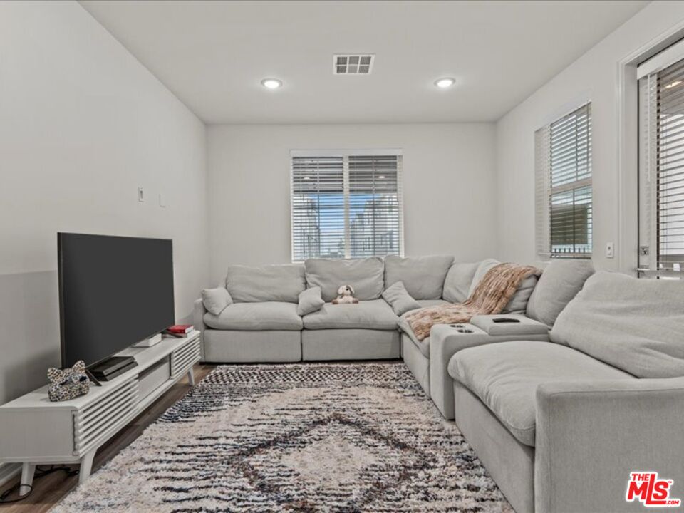 17923 Goodyear Carson, CA 90746 - Photo 11 of 17 a living room with furniture and a flat screen tv