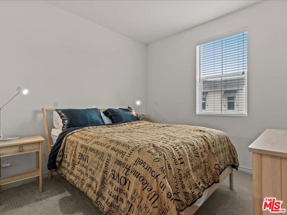 17923 Goodyear Carson, CA 90746 - Photo 12 of 17 a bedroom with a bed and window