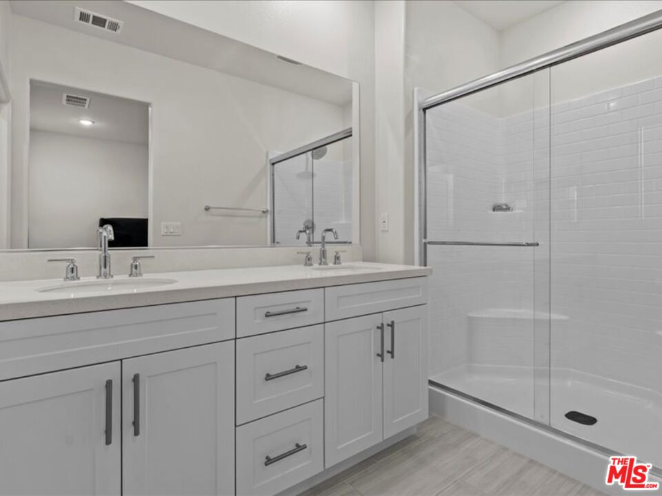 17923 Goodyear Carson, CA 90746 - Photo 14 of 17 a bathroom with double vanity sink and shower