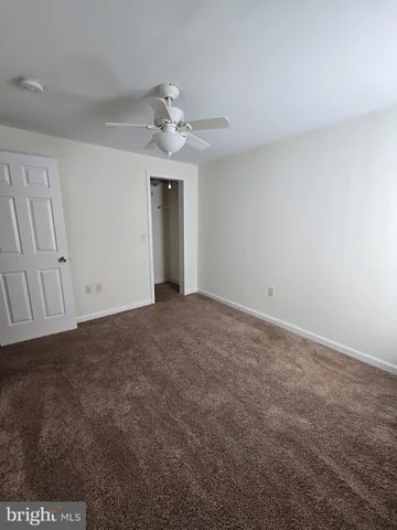 a view of an empty room with a ceiling fan