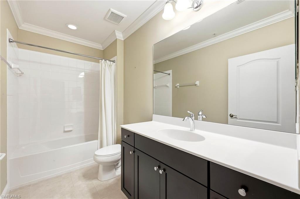 6980 Avalon Circle, Unit 1102 Naples, FL 34112 - Photo 13 of 24 Full bathroom featuring vanity, ornamental molding, shower / bath combo, and light tile patterned floors