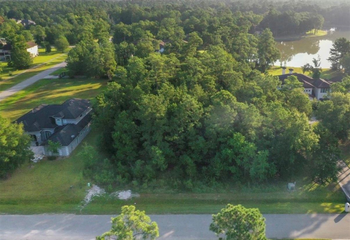 4007 Hidden Winds Drive Spring, TX 77386 - Photo 6 of 9 a view of a lake with a yard