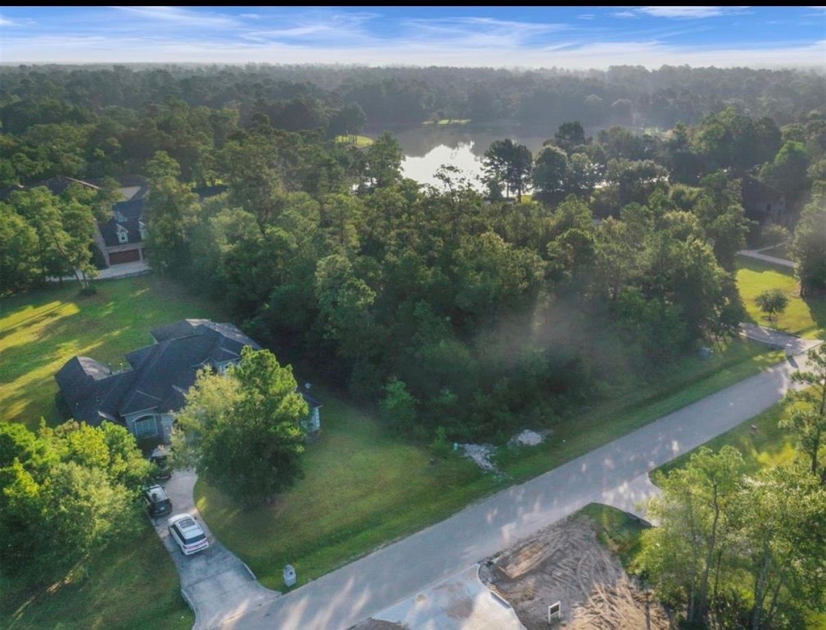 4007 Hidden Winds Drive Spring, TX 77386 - Photo 9 of 9 a view of a lake with a yard