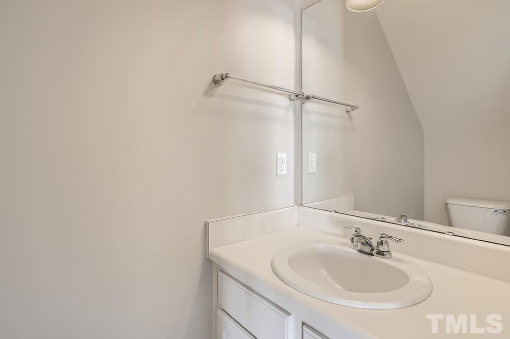7222 Racine Way Raleigh, NC 27615 - Photo 14 of 27 a bathroom with a sink and a mirror