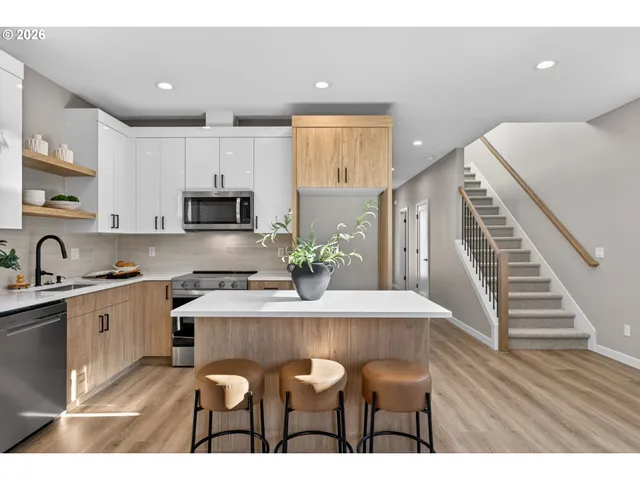 a kitchen with furniture and wooden floor