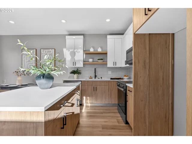 a kitchen with a sink appliances and cabinets