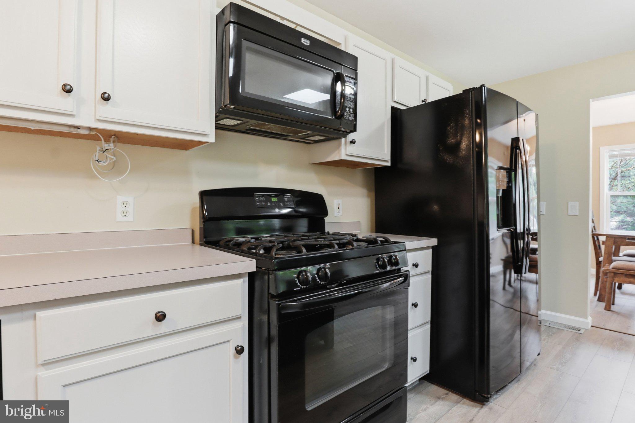 491 Garvine Mill Road Fawn Grove, PA 17321 - Photo 10 of 47 a kitchen with stainless steel appliances granite countertop a stove microwave and refrigerator