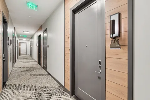 a view of a hallway with wooden floor