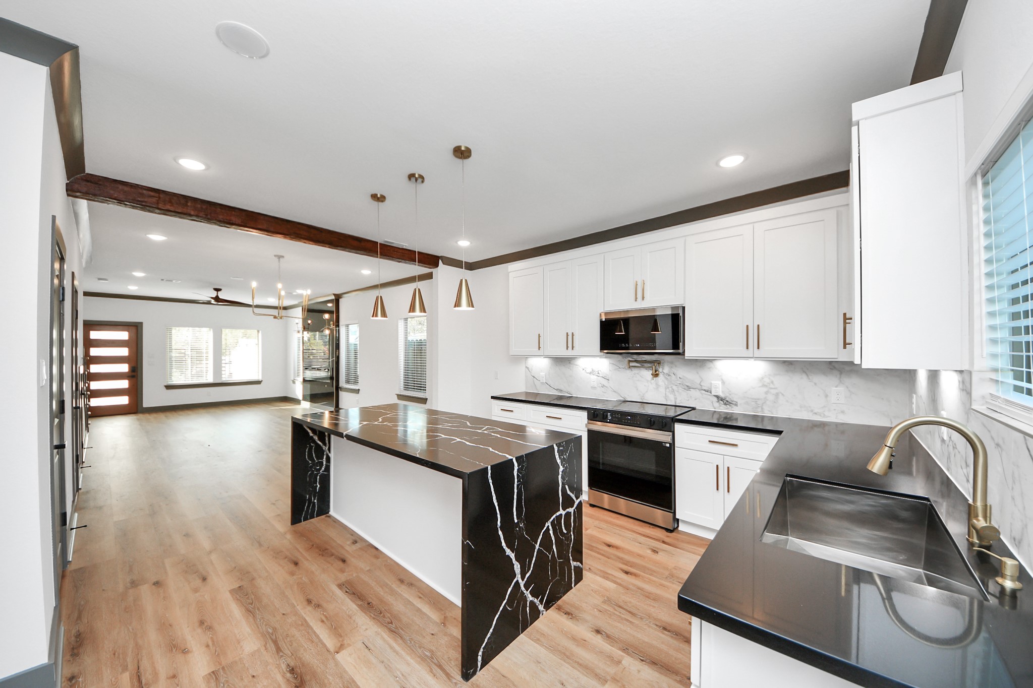 7925 Ritz Street, Unit B Houston, TX 77028 - Photo 16 of 35 a kitchen with stainless steel appliances granite countertop a sink stove and refrigerator