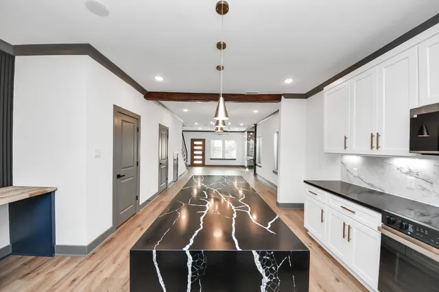 a large kitchen with granite countertop lots of counter space