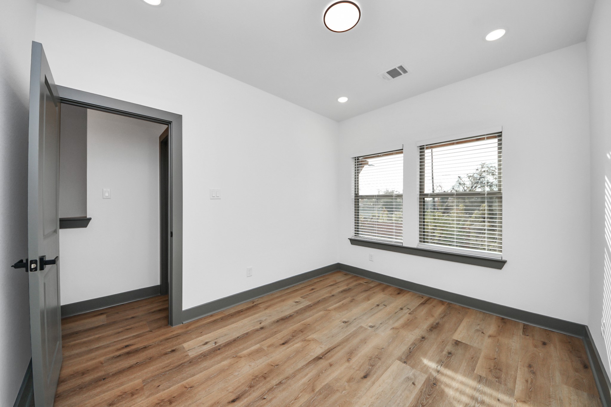 7925 Ritz Street, Unit B Houston, TX 77028 - Photo 29 of 35 a view of an empty room with wooden floor and a window