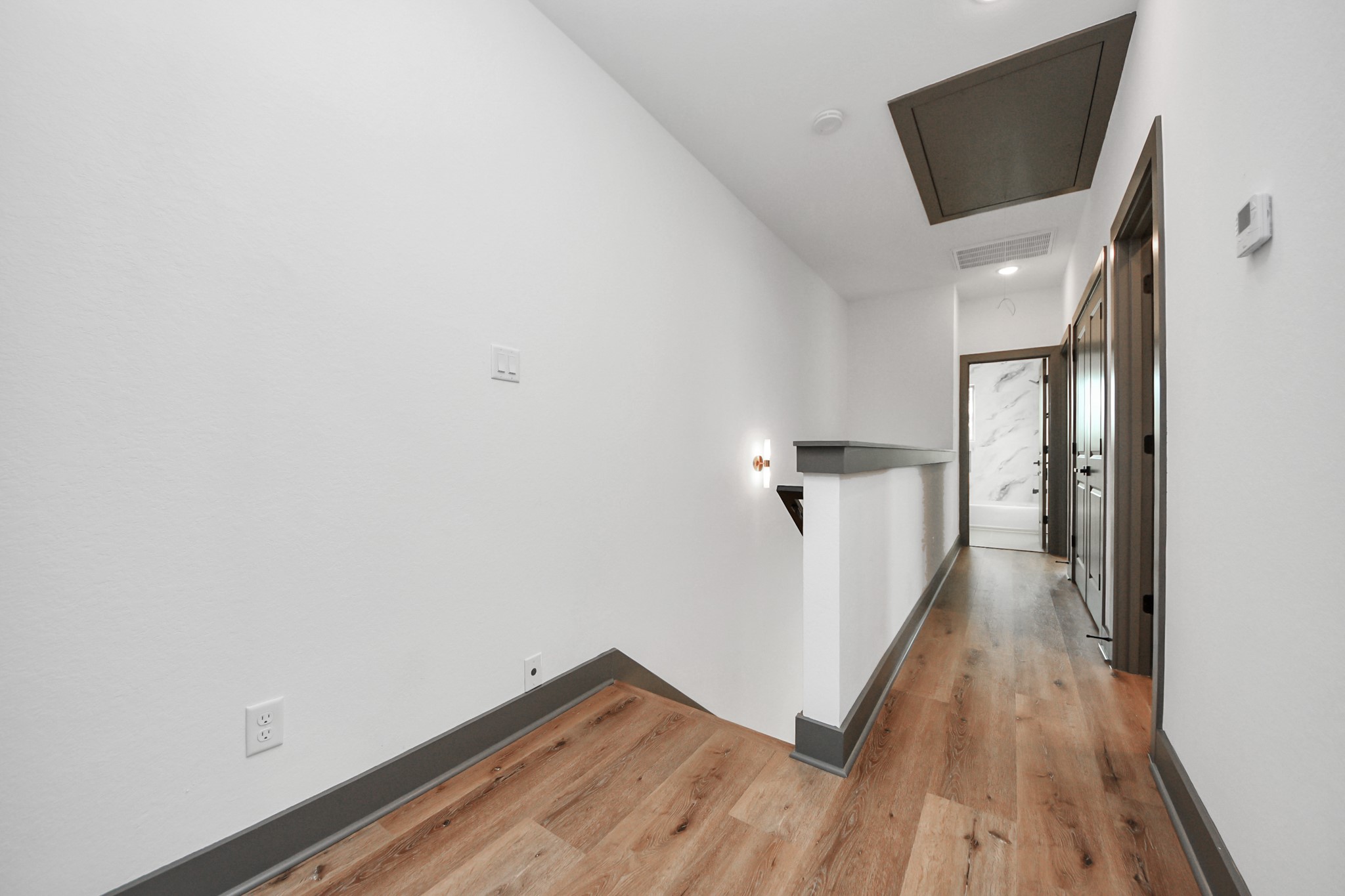 7925 Ritz Street, Unit B Houston, TX 77028 - Photo 32 of 35 a view of a hallway with wooden floor and staircase