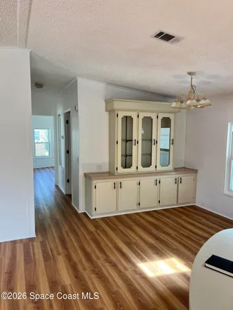a view of a bedroom with wooden floor