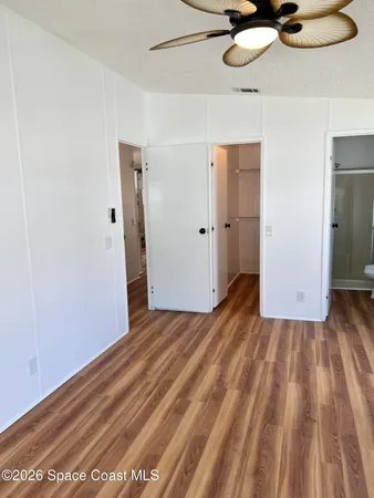 a view of a room with wooden floor
