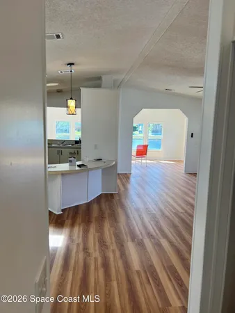 a view of a living room and hardwood floor