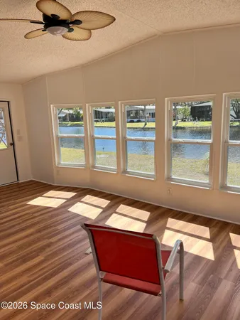 a room with wooden floor and windows