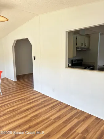 a view of a room with wooden floor