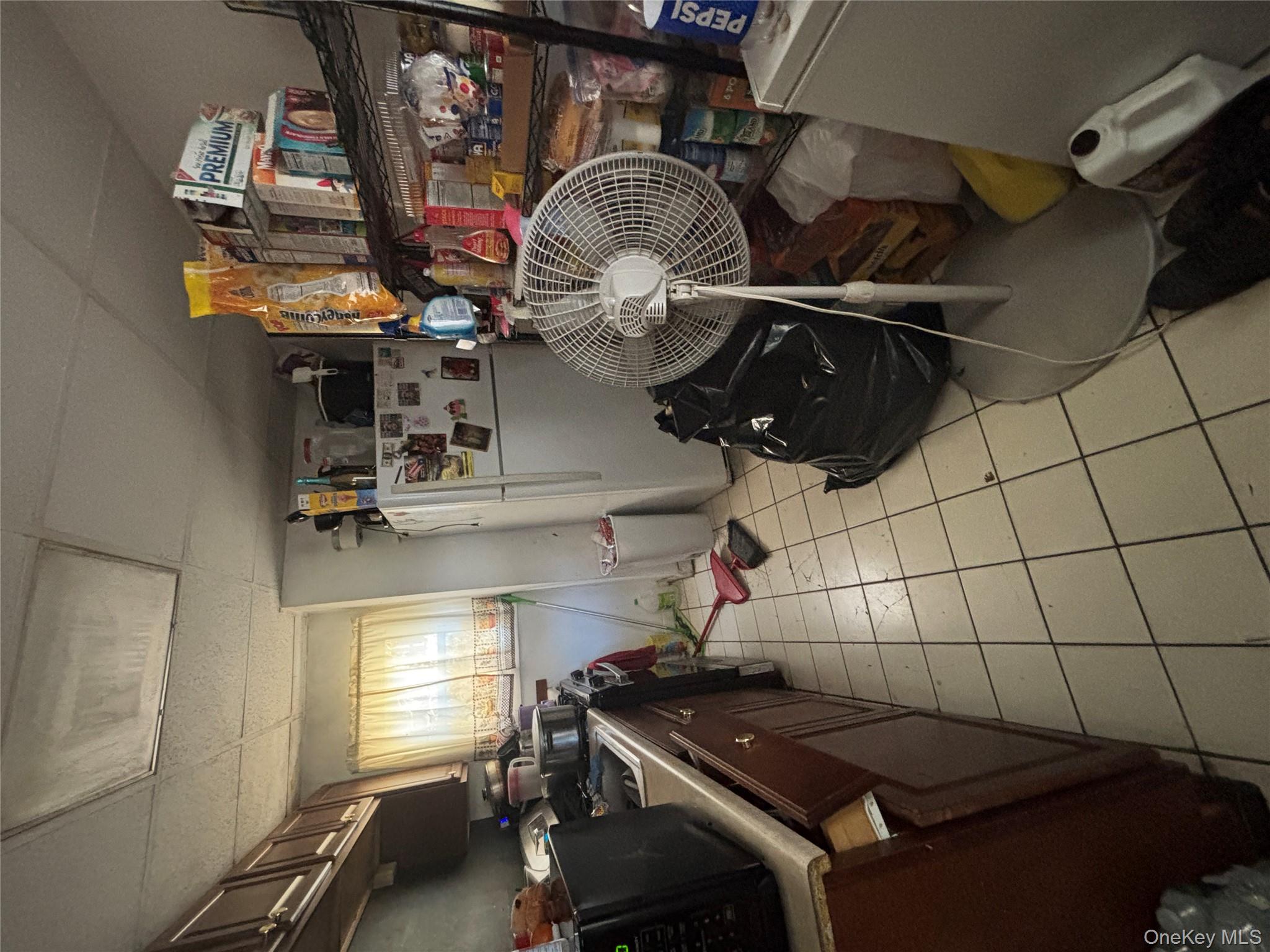 1340 Main Street Peekskill, NY 10566 - Photo 16 of 24 a room with furniture a flat screen tv and a floor to ceiling window