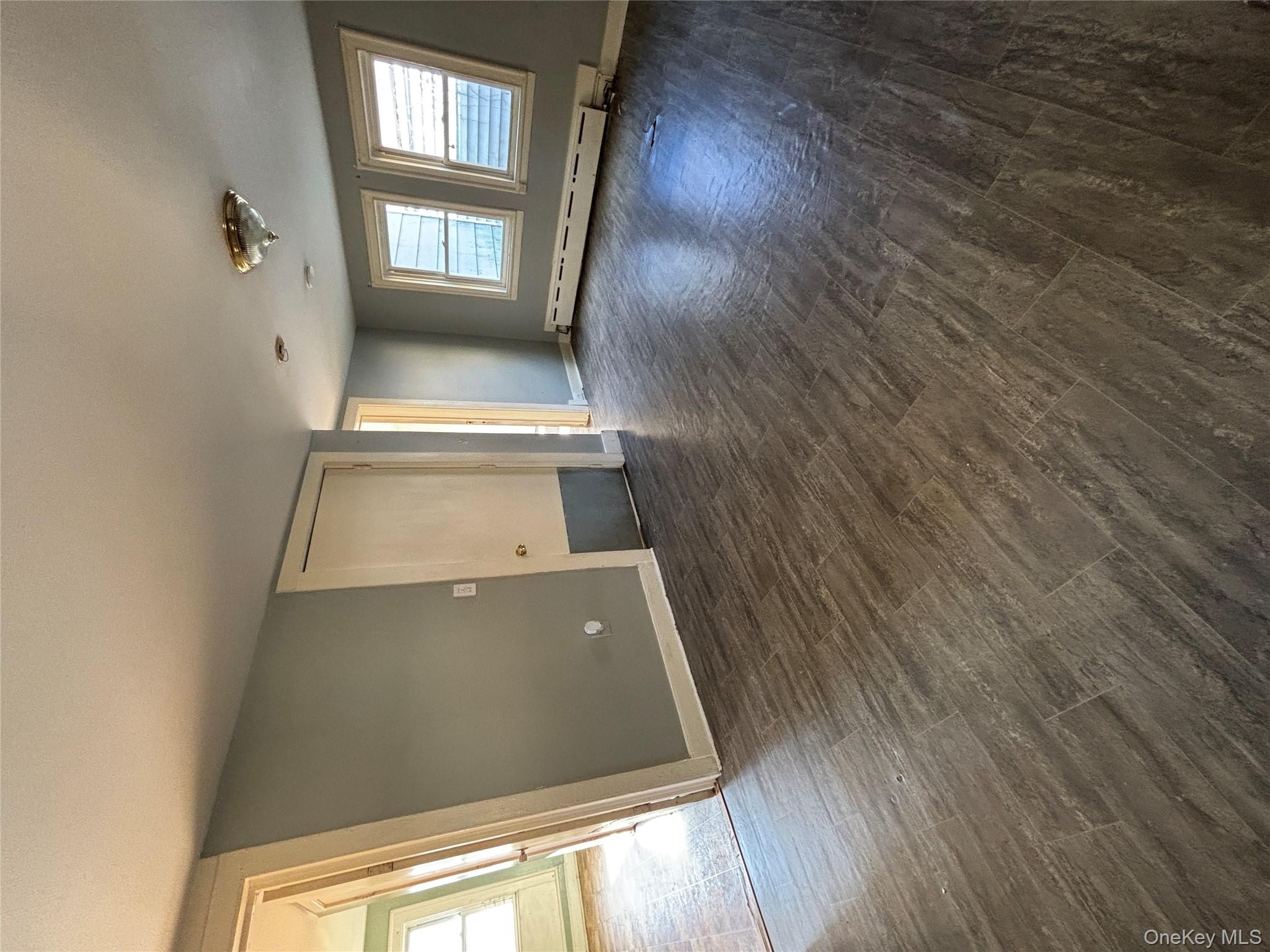 1340 Main Street Peekskill, NY 10566 - Photo 5 of 24 an empty room with wooden floor and windows