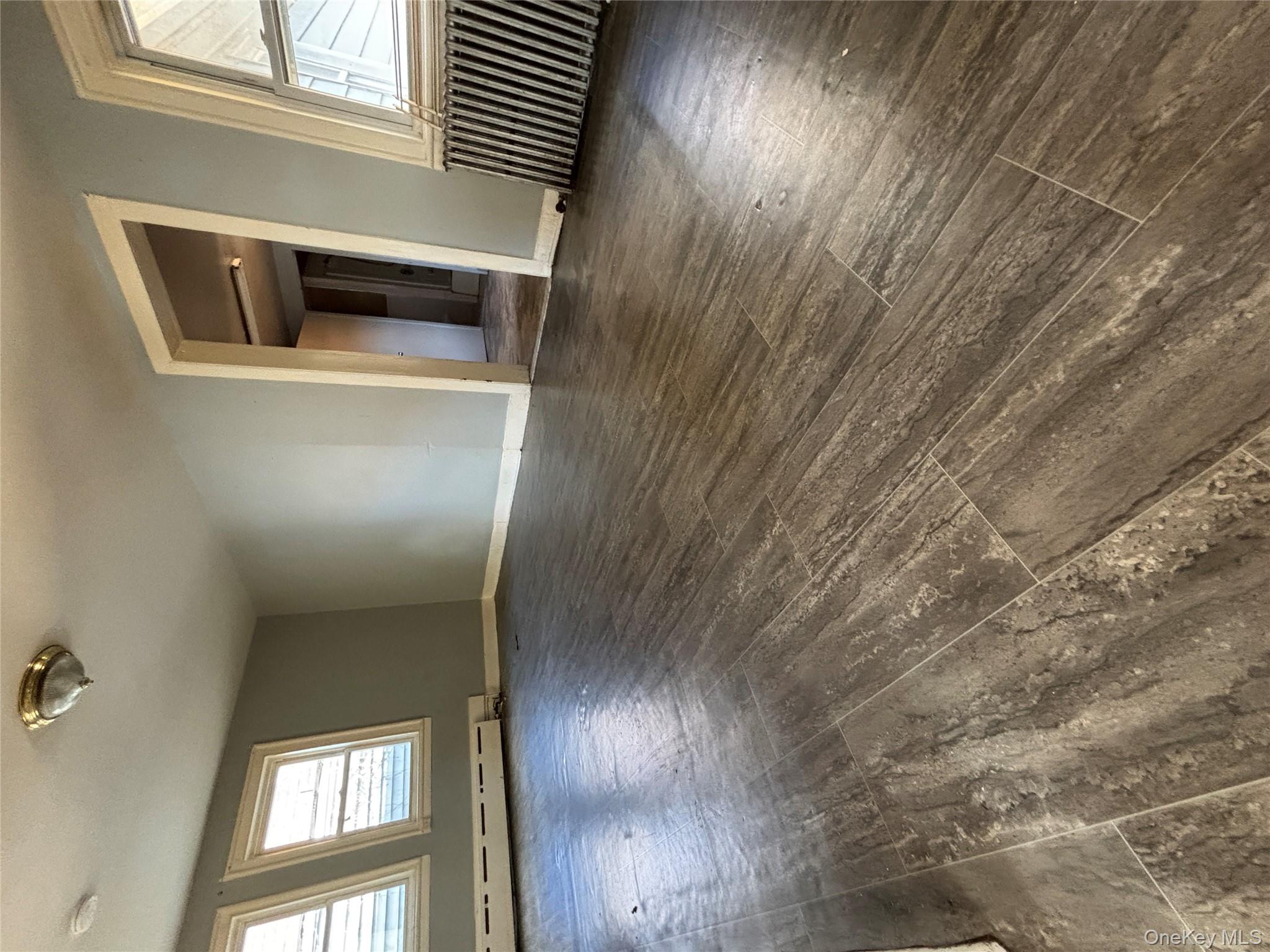 1340 Main Street Peekskill, NY 10566 - Photo 6 of 24 an empty room with wooden floor and windows